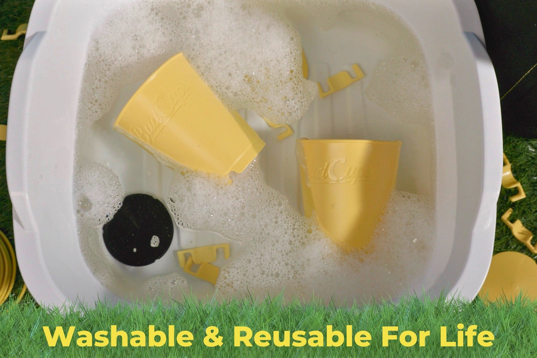 BudCups being washed in soapy water, demonstrating reusability and easy cleaning.