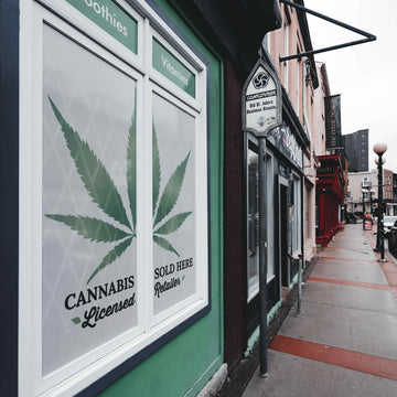 Cannabis storefront with a cannabis leaf sticker on the window