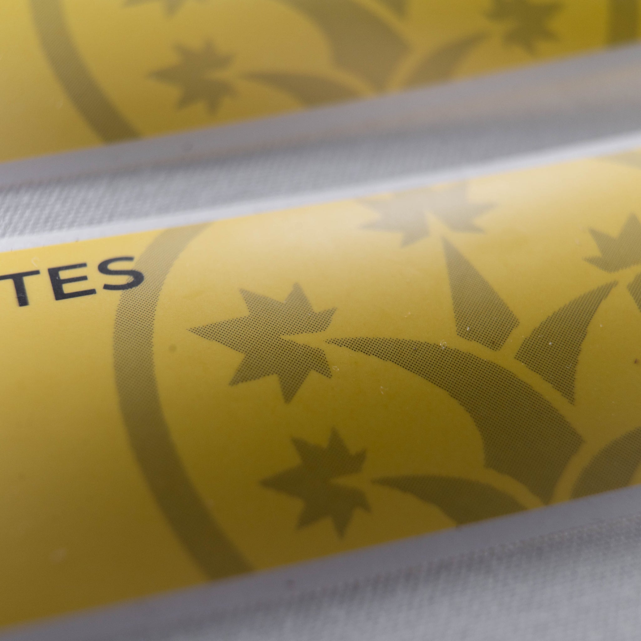 Macro shot of BudTrainer yellow sticky notes with cannabis grow logo and notes section.